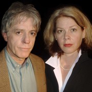 Serious-looking gray-haired man and blonde woman